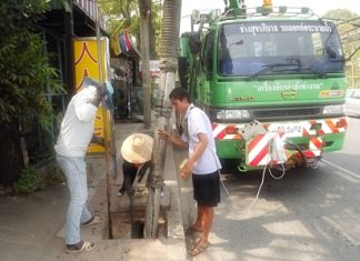 Pattaya Engineering Department workers clear storm drains along Second Road.